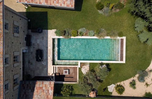 Montelier House | A magnificent stone mansion with a large swimming pool and a hot tub.