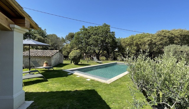 Provencal farmhouse on a hillside surrounded by centuries-old olive and oak trees